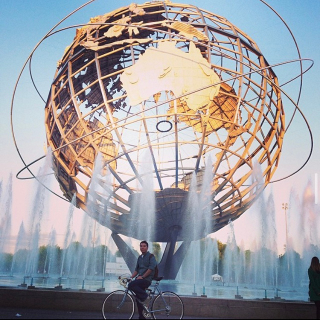 Andy Doro with bicycle at the Unisphere in Flushing Meadows Corona Park.